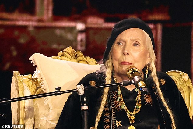 Joni sat in a graceful roll that slowly spun, revealing her to the crowd