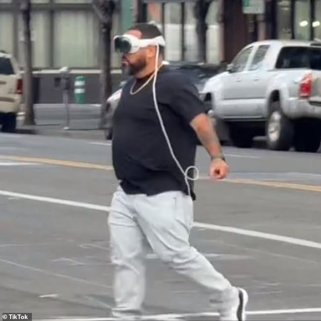 Apple officially launched the new $3,500 Vision Pro at retail on Friday, and fans have been posting videos of themselves using the new technology in everyday life.  A man crosses the street wearing an Apple headset