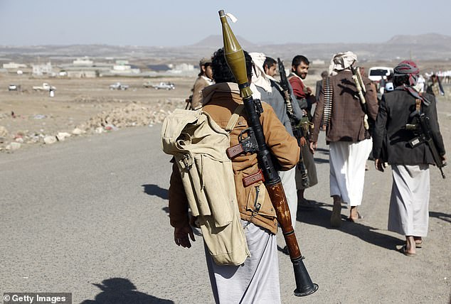 Houthi fighters are pictured walking to attend a rally in support of Palestinians in the Gaza Strip, and the recent Houthi attacks on shipping in the Red Sea and Gulf of Aden on February 4