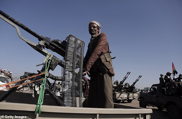 Yemeni Houthi fighter is pictured manning a vehicle-mounted heavy machine gun during a rally in support of Palestinians in the Gaza Strip