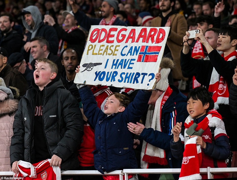 A young supporter stood at the front of a stand and held up a sign after the final whistle asking for Odegaard's jersey.