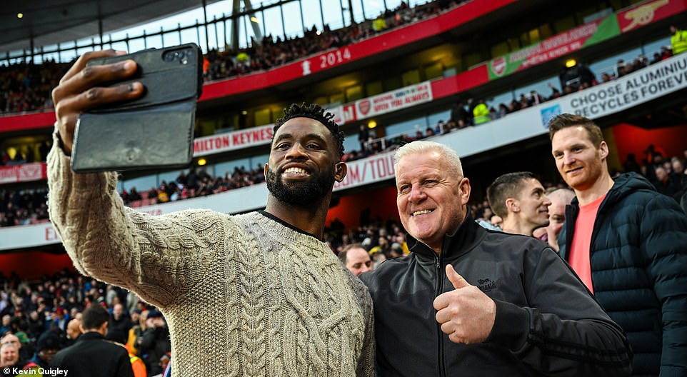 Liverpool supporter and South African Rugby Union captain Siya Kolisi (left) took several photos next to the supporters