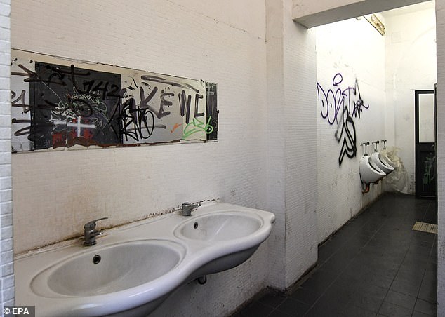 The rape in the public toilet (pictured) lasted 30 minutes until the couple were finally able to break free and escape.  They immediately alerted the Carabinieri, who captured the group within 24 hours