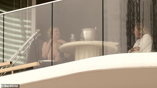 The group enjoyed a glass of white wine and some snacks as they relaxed on the balcony