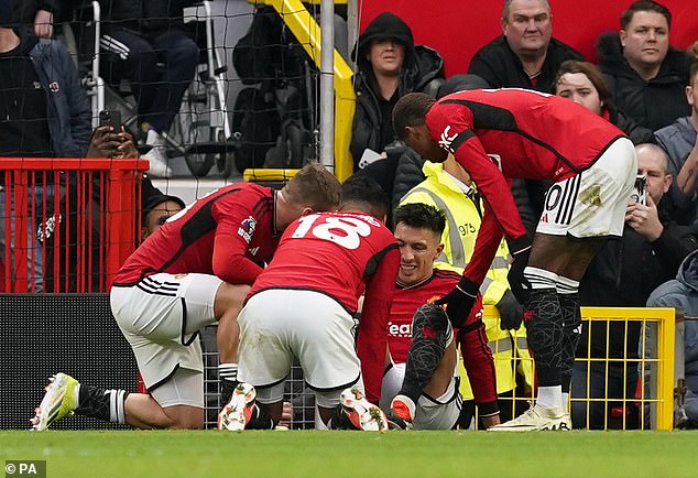 Concerned teammates surrounded Martinez after the collision with the Hammers defender