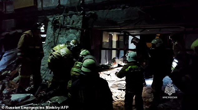 This excerpt from a handout material released by Russia's Emergency Situations Ministry on February 3, 2024, shows rescuers clearing rubble, extracting victims' bodies and searching for survivors in a destroyed bakehouse hit by recent shelling in the city of Lysychansk