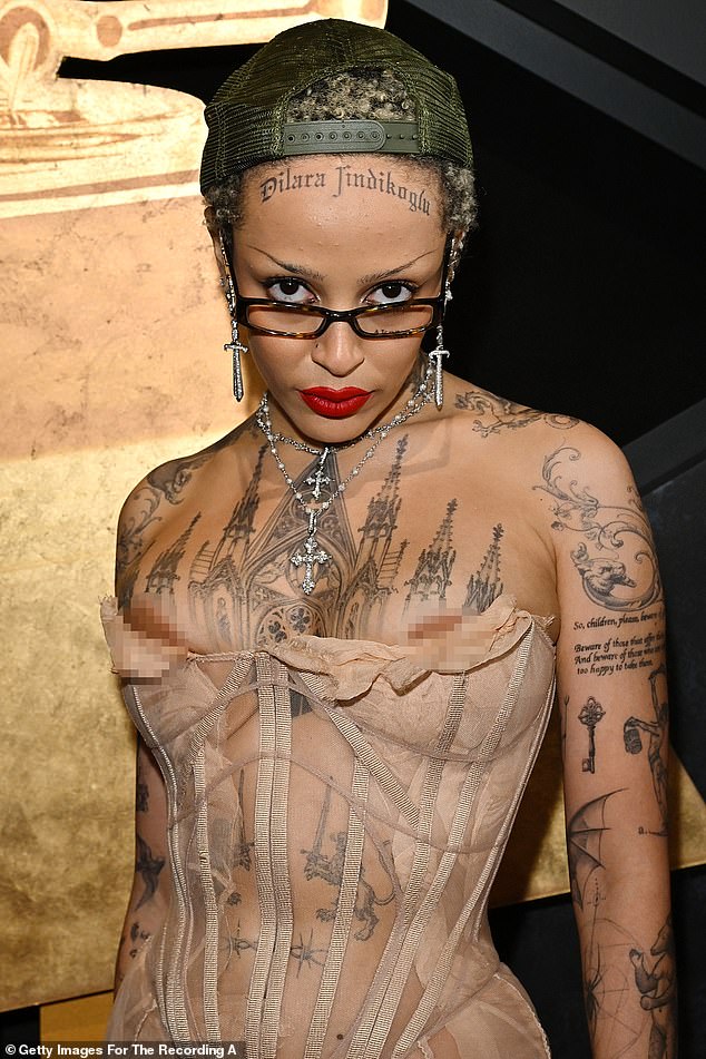 What was Doja Cat – in that nipple peek-a-boo, monstrous forehead tattoo – thinking?