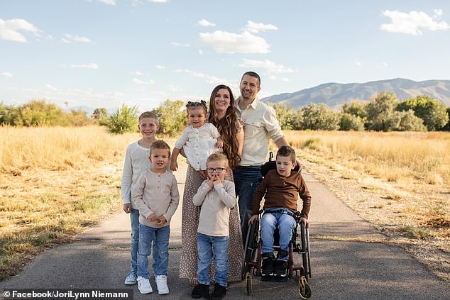 In the photo: the Neiman family.  Daniel and JoriLynn surrounded by their five children.  Ripplen stands in front of his mother with glasses