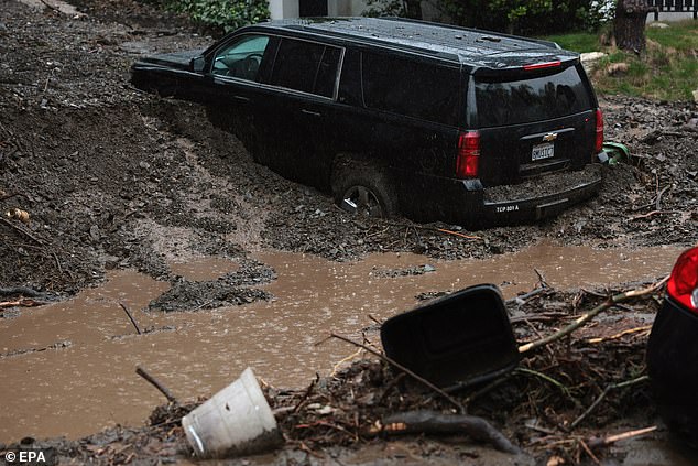 Vehicles remain stuck by a mudslide as a powerful atmospheric river storm hits Southern California in Beverly Hills