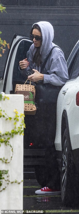 The beauty bundled up under her gray hoodie