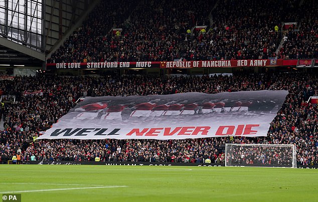 The service was held at Old Trafford in memory of the 23 people who died in the 66th anniversary tragedy.  Pictured: Fans pay tribute during their team's match against West Ham