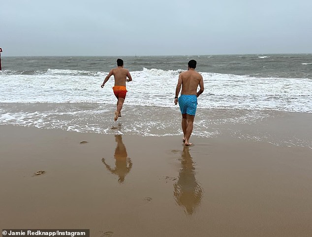 The trio took the plunge into the icy water on the beach on Tuesday morning, before posing together in their swimming trunks