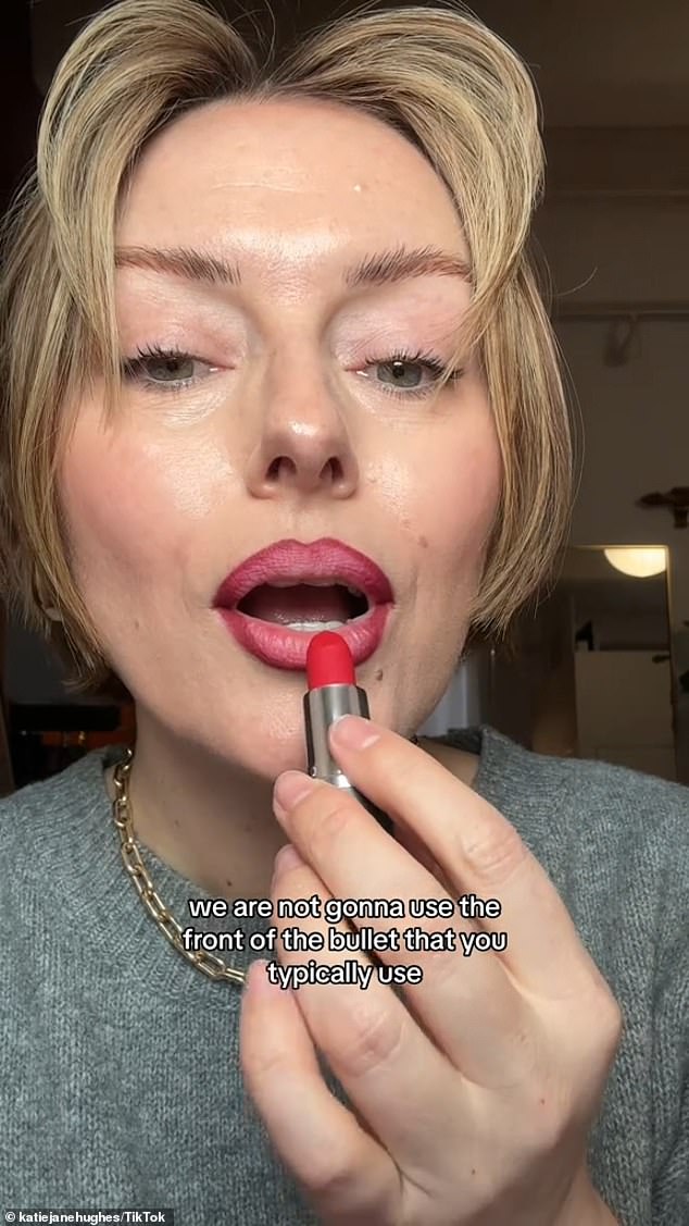 After priming her lips, she uses the Simi Haze pencil, freshly sharpened in the shade Omen, to first define the bottom lip and then the center, before applying the lipstick upside down.