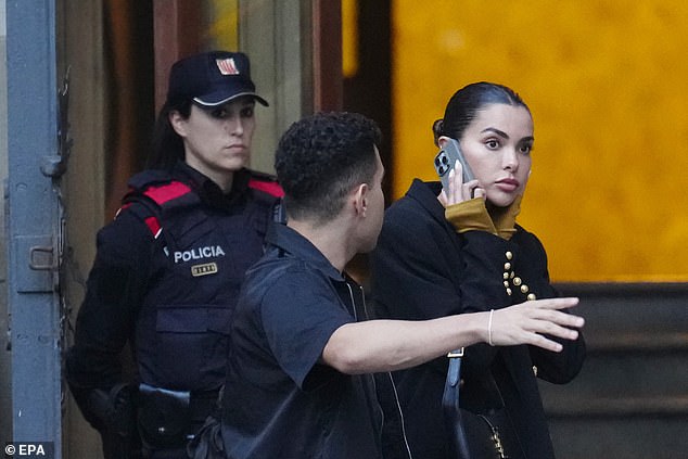 Ms Sanz leaves court after giving evidence in which she said Alves 'smelled of alcohol' when he arrived at their home outside Barcelona in the early morning