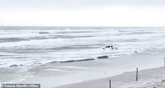 The man's car is seen spinning in the choppy waters just before police approached him about the bizarre incident