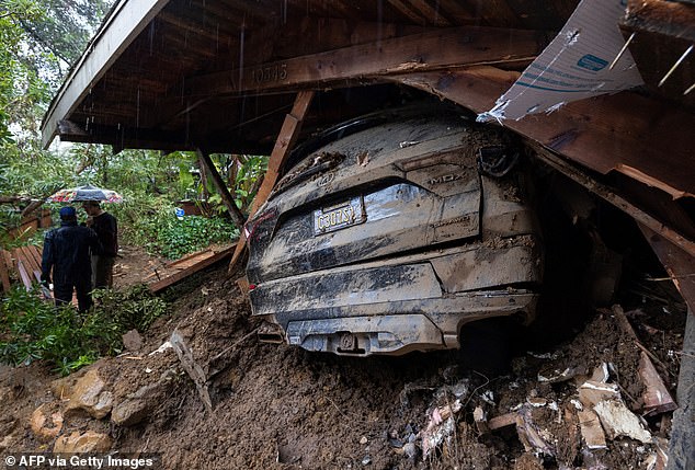 Wind gusts of up to 120 km/h were recorded in parts of the Golden State.  Pictured: A car was damaged by debris during a storm in Los Angeles' Studio City neighborhood on Tuesday