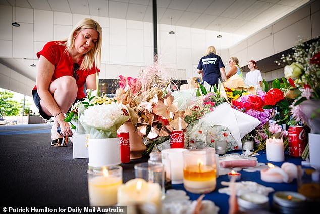 Local woman Melissa Halliday visits a supermarket memorial on Tuesday as residents call on the government to tackle youth crime