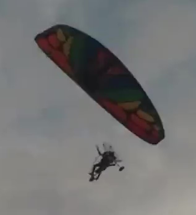A Hamas paraglider is photographed crossing the border on October 7