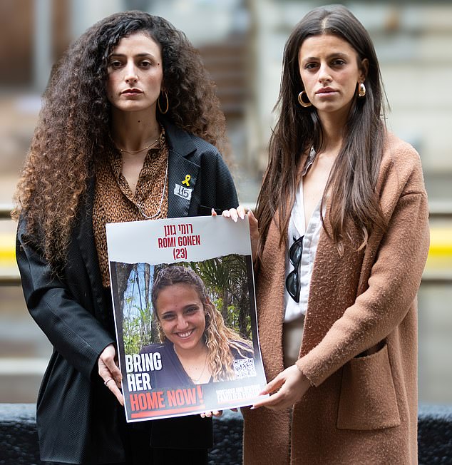 Romi's sister Yarden (left) is pictured holding up a photo of Romi with Ben's grieving girlfriend, Jessica