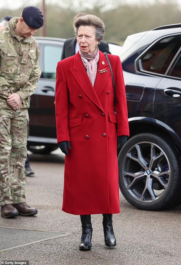 Anne was impeccably dressed in a red pillar coat, which she debuted in 2005, and knee-high leather boots