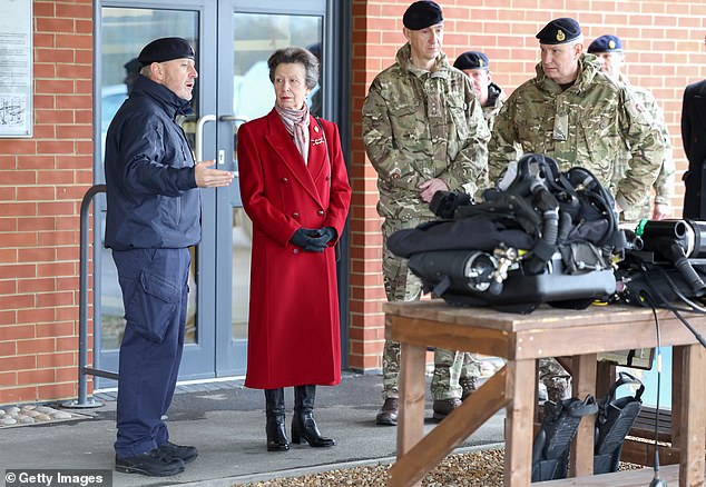 Princess Anne listens to Lieutenant Darren Powell, underwater explosives disposal specialist for the Royal Navy