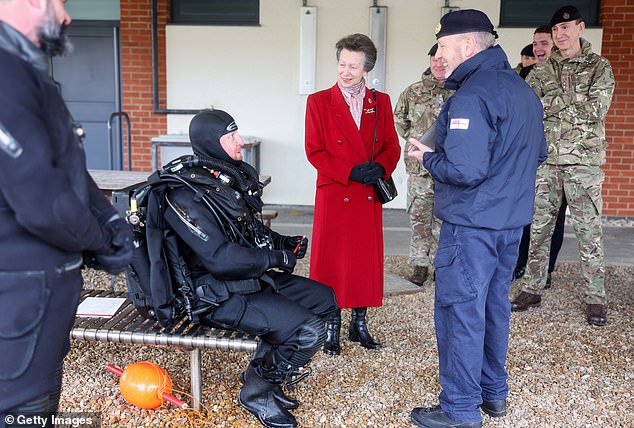 Princess Anne smiles as she speaks to the specialist underwater explosives operator