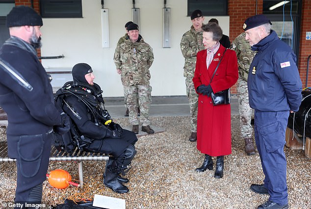 The royal family listened intently to several military personnel during their visit to St. George's Barracks