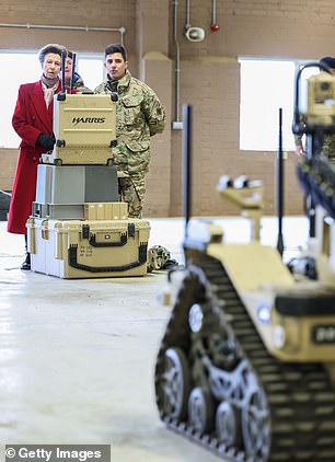 Anne speaks and sees a demonstration with an explosive ordnance disposal robot during her visit to the Defense Explosive Ordnance Disposal Training Regiment