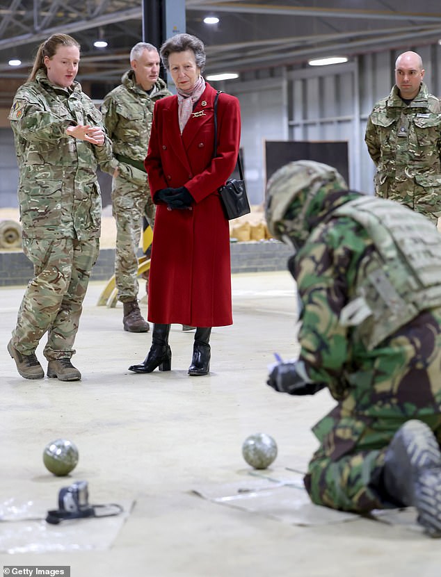 The Princess Royal speaks to soldiers as she watches a demonstration in the indoor training area during her visit