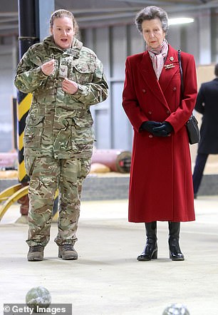 During her visit, Anne watches a demonstration in the indoor training room