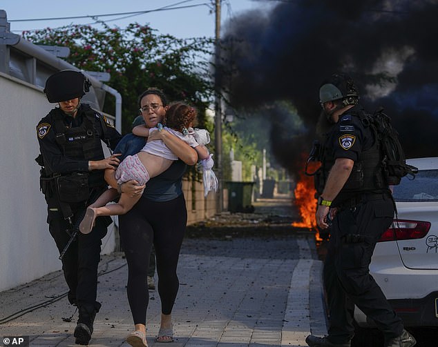 The photo shows a mother and child evacuating their home on October 7, when the conflict broke out