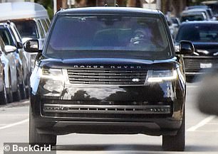 The Duchess kept one hand on the steering wheel as she sipped from a coffee mug