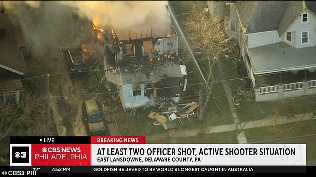 Two officers have been shot during an active shooting near Philadelphia at a house that was set on fire