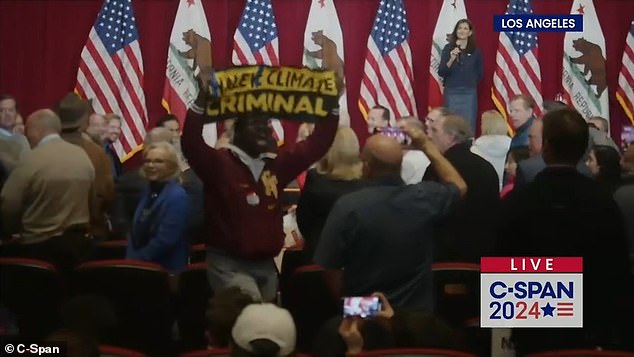 One climate change activist interrupted Haley's comments and held up a sign that read: 