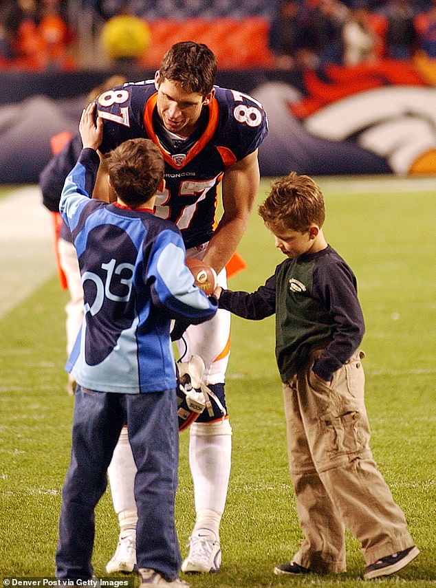 Christian (R) is pictured with wide receiver Ed and his older brother Max after a game in 2002