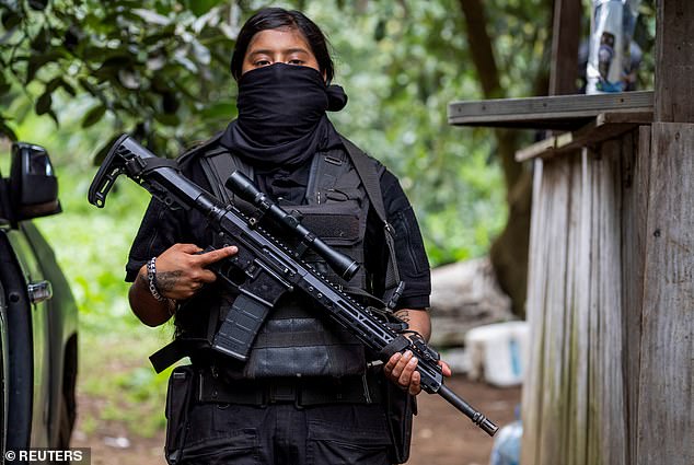 A female member of the Jalisco New Generation Cartel holds a sniper rifle