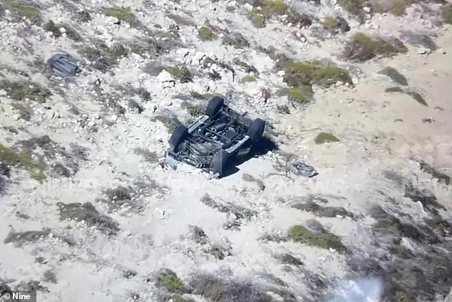 The 21-year-old sole survivor of the crash managed to climb out of the wreckage (pictured), scale the cliff and walk to the road.  He remains in a stable condition at Royal Perth Hospital