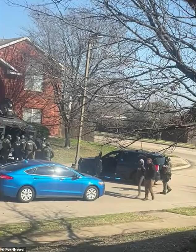 Top barricaded herself in the attic of her home for an hour until police forced chemicals into the house and forced her to come out.  She was led away in handcuffs