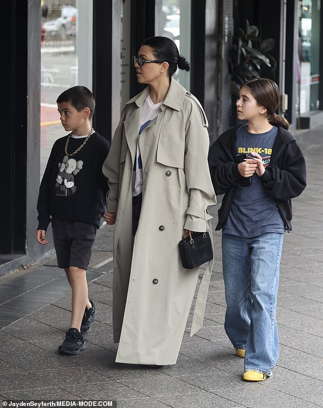 The 44-year-old paired the stylish jacket with shorts and a baseball jersey, along with leather loafers and socks