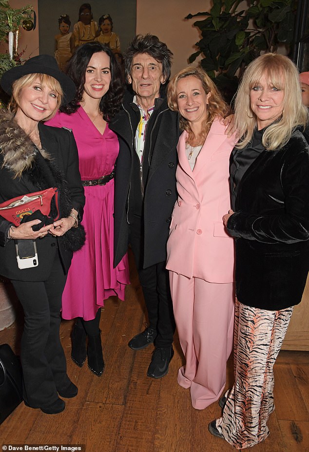 Speaking about her experiences with The Rolling Stones, she astonishingly said: 'The Stones would pat me on the head like a little sister, which always annoyed me because I wanted to be their equal' (Lulu, left, pictured with The Rolling Stones).  Ronnie Wood of Rolling Stones, center, in 2019)