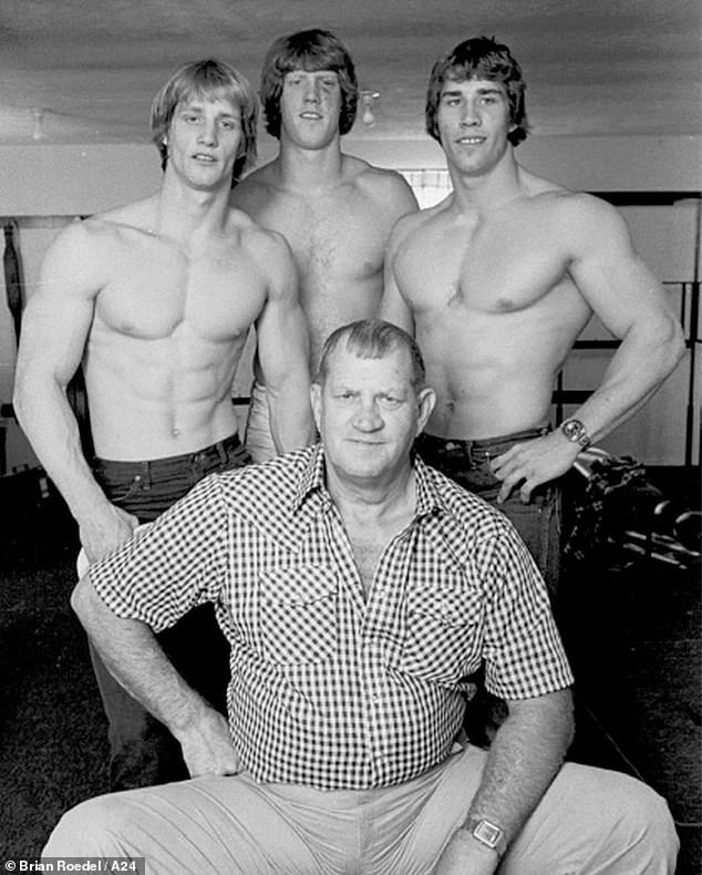 The Iron Claw follows the tragic true story of the Von Erich family, who made history at the forefront of the world of professional wrestling in the early 1980s.  In the photo: brothers (LR) Kevin, David and Kerry with their champion father Fritz