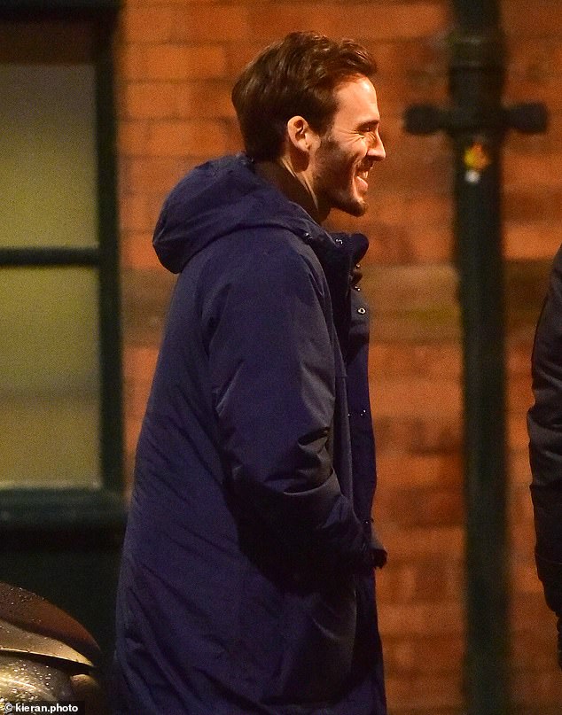 The Hunger Games alum was then captured beaming in the street as he swapped his smart coat for a navy blue padded jacket