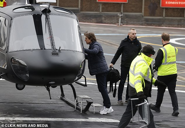 Tom piloted the matte black helicopter himself and landed on the helipad