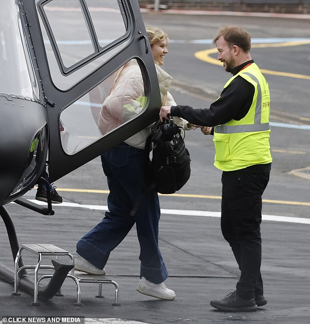 Tom's female companion wore a cream padded jacket with a beige sweater and wide leg jeans and trainers