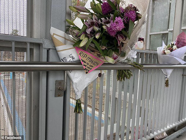 Mandy's relatives have created a memorial at the train station with bouquets of flowers, candles and notes