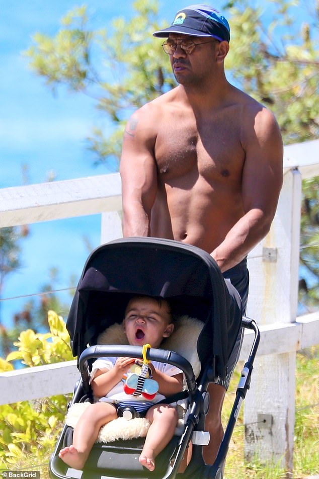 Beale, pictured taking his son, also named Kurtley Beale, for a walk, and his wife Maddie are set to welcome their second child in May