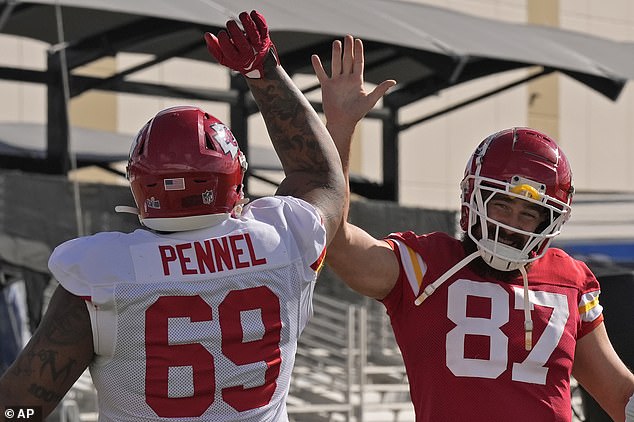 Tight end Kelce high fives defensive tackle Mike Pennel Jr.  as they complete their preparations