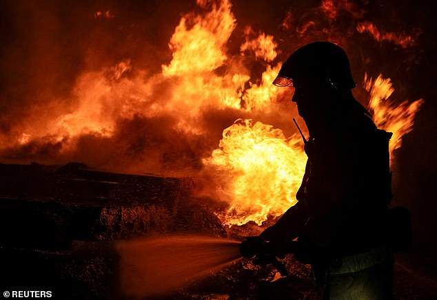 A firefighter works at a Russian drone attack site in Kharkiv, Ukraine on February 10, 2024