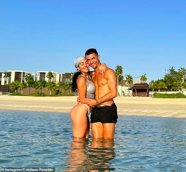 Ronaldo and Georgina pose for a photo in the sea during their sunshine in Dubai