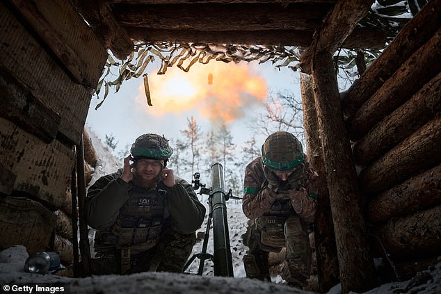 Mortar platoon soldiers with an 82mm mortar carry out a combat mission as Ukrainian soldiers hold their positions in the snow-covered Serebryan Forest in temperatures of -15 °C, January 2024 in Kreminna, Ukraine